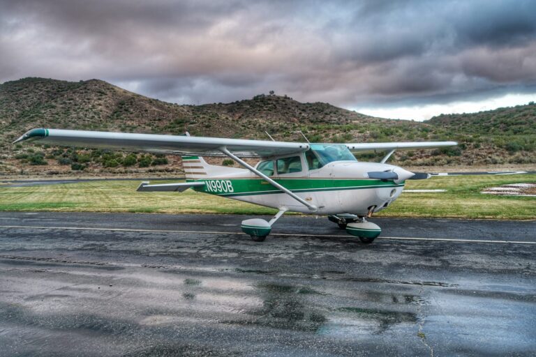 Cessna 172 sits on wet Van Nuys runway with storm passing in the background