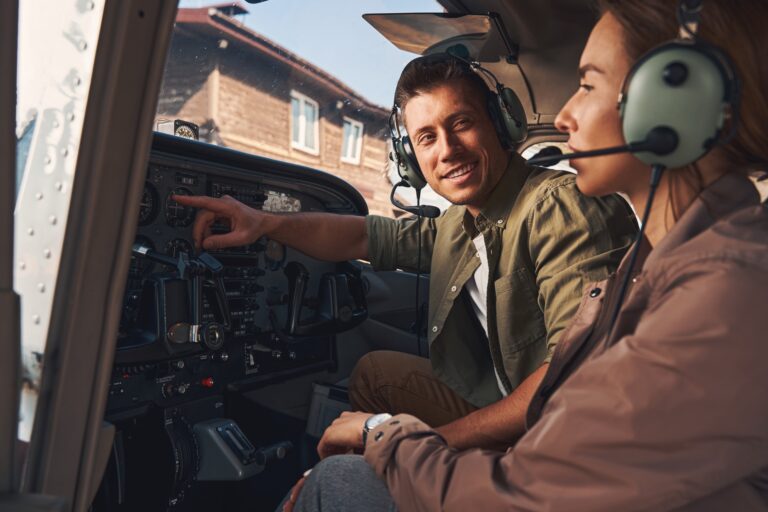 Flight instructor and student prepping for upcoming lesson in cockpit of small airplane at Van Nuys Airport.