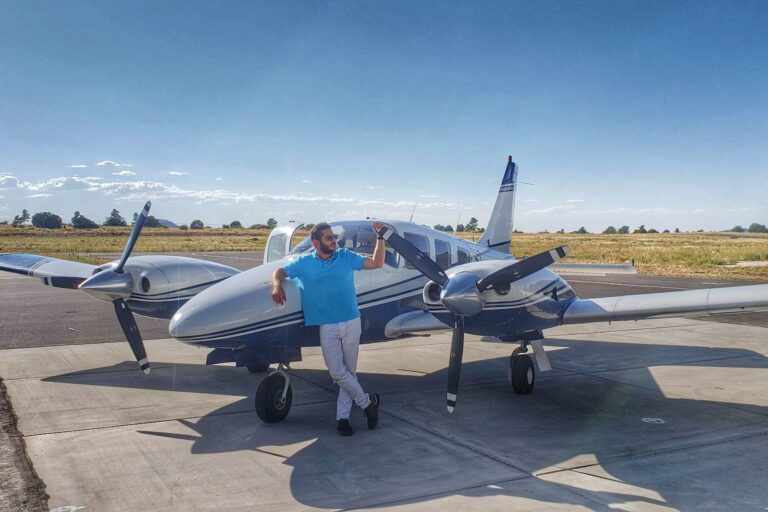 Flight instructor poses with twin engine plane before Multi-Engine Flight Training