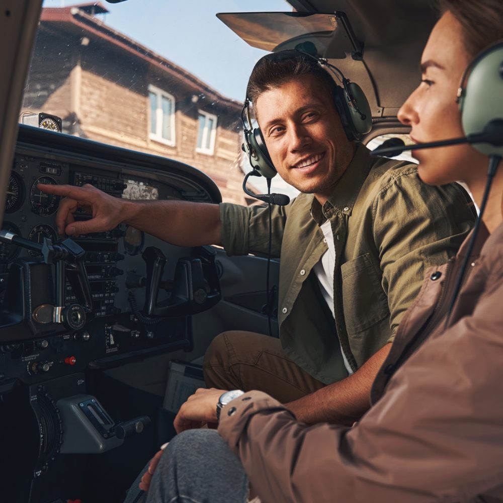 Flight instructor and student prepping for upcoming lesson in cockpit of small airplane at Van Nuys Airport.
